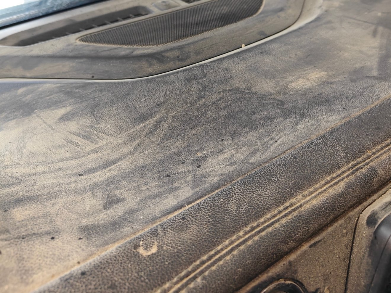 Dashboard caked in dust and grime before detailing